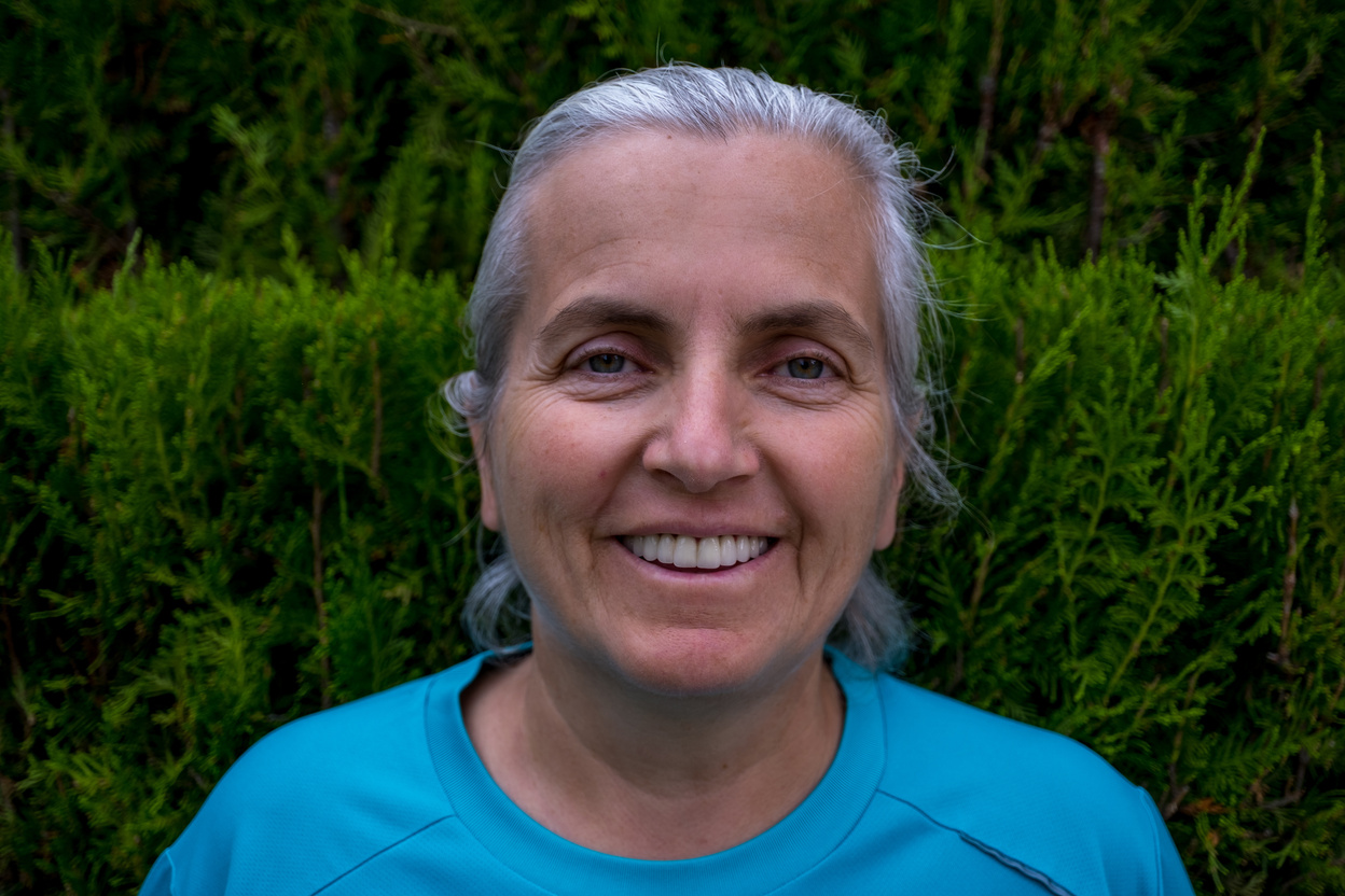 Portrait of 55 years old white hair with green eyes laughing